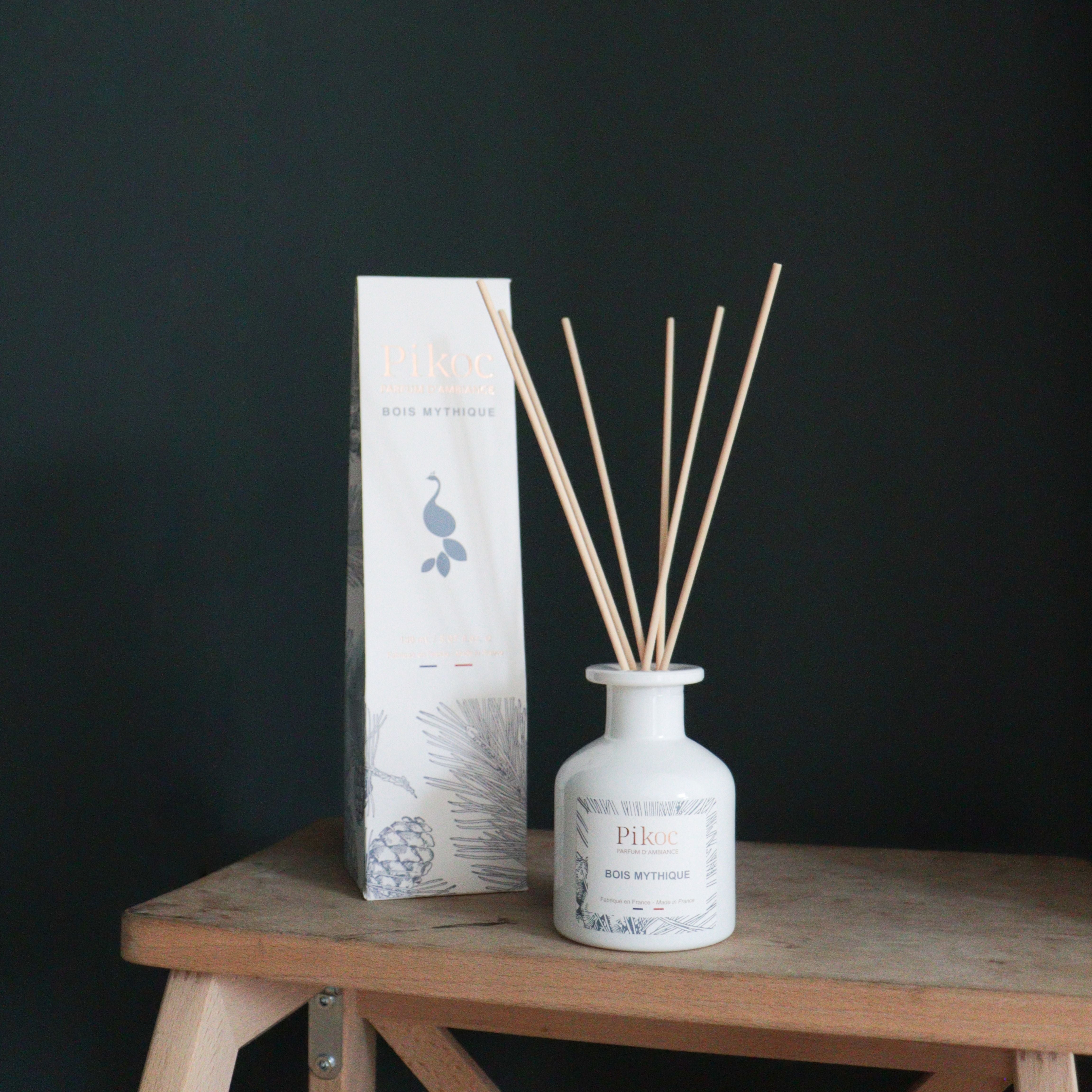 Parfum d’ambiance Pikoc Bois Mythique, 150mL, posé sur un marche pied avec son packaging